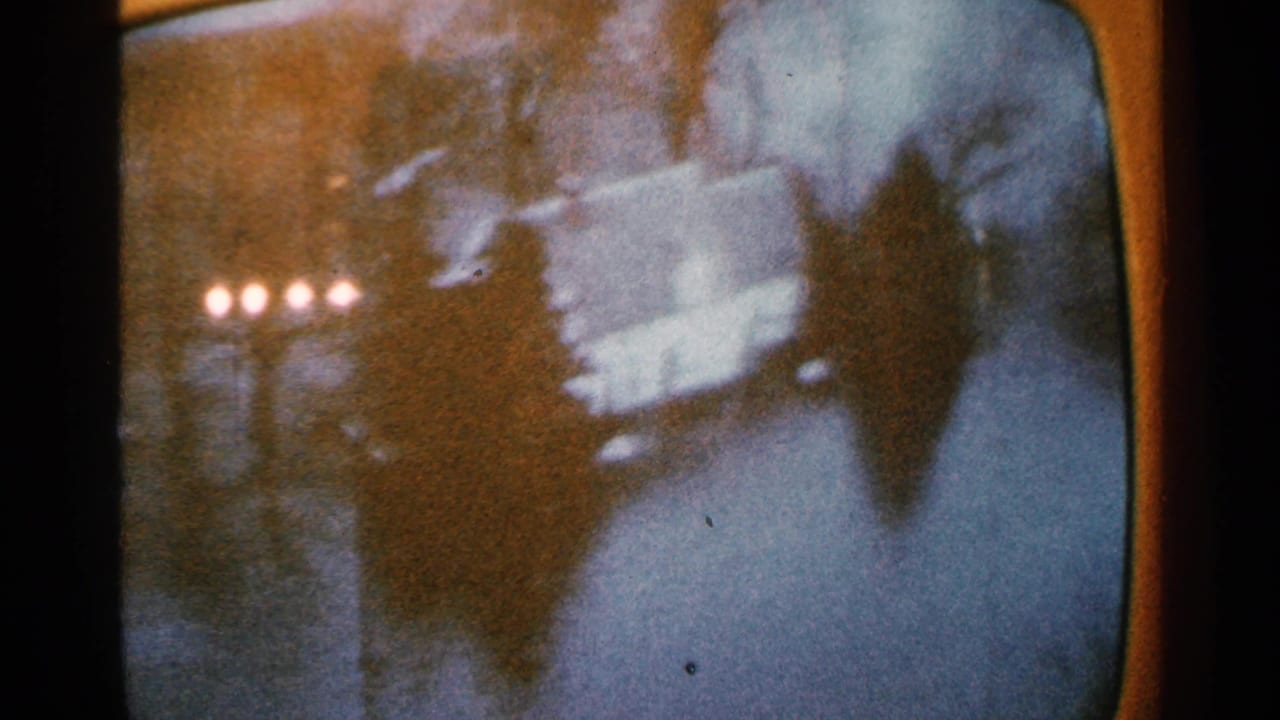 Dim flood aftermath scene with water, dark silhouettes and reflected lights.