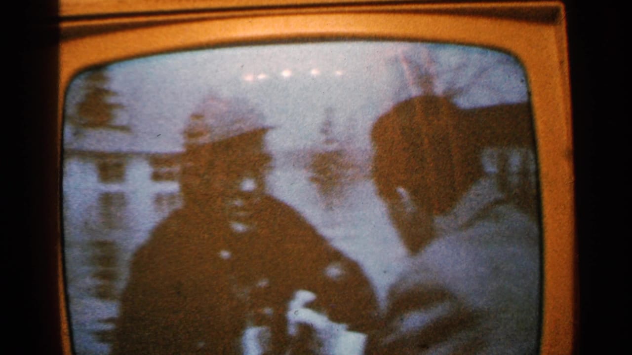 Television screen with two silhouetted figures facing each other.