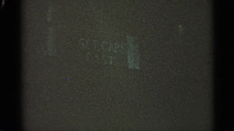 A mostly obscured 8mm frame with dark borders and minimal visible flood-scene detail at the start of the clip.
