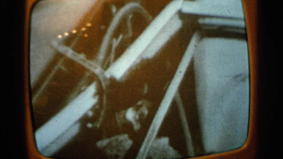 Soft 8mm close-up from inside the vehicle, with wheel spokes, trim, and bright snow outside in Minnesota.