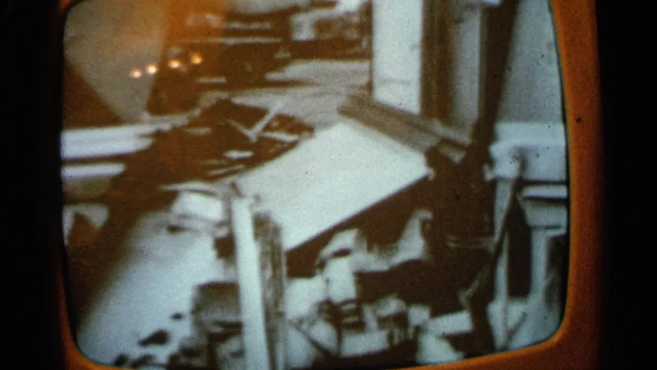 Final 1965 Minnesota frame holds on a vintage television broadcast with indistinct debris-like forms and reflective screen glare.