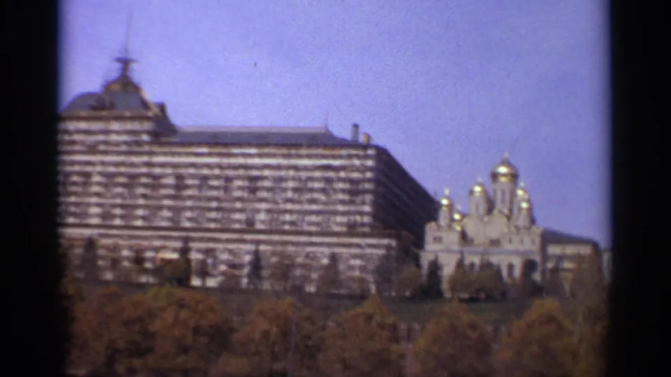 1965 Moscow frame with the State Kremlin Palace, golden-domed Orthodox churches, and trees in the foreground.