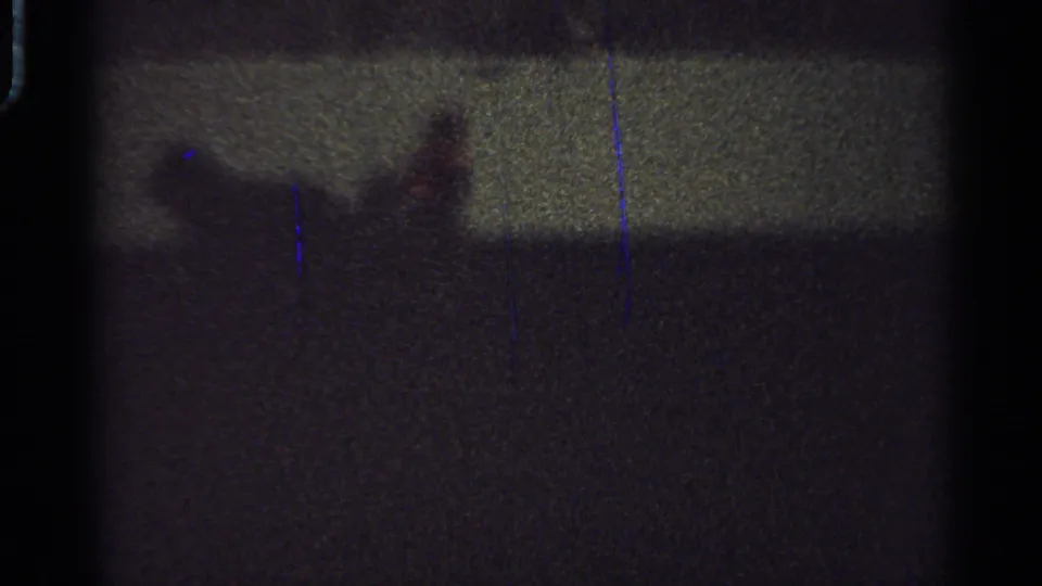 Low-light 1965 Saint Louis frame with the rider and horse reduced to a blurred silhouette near the horizon line.