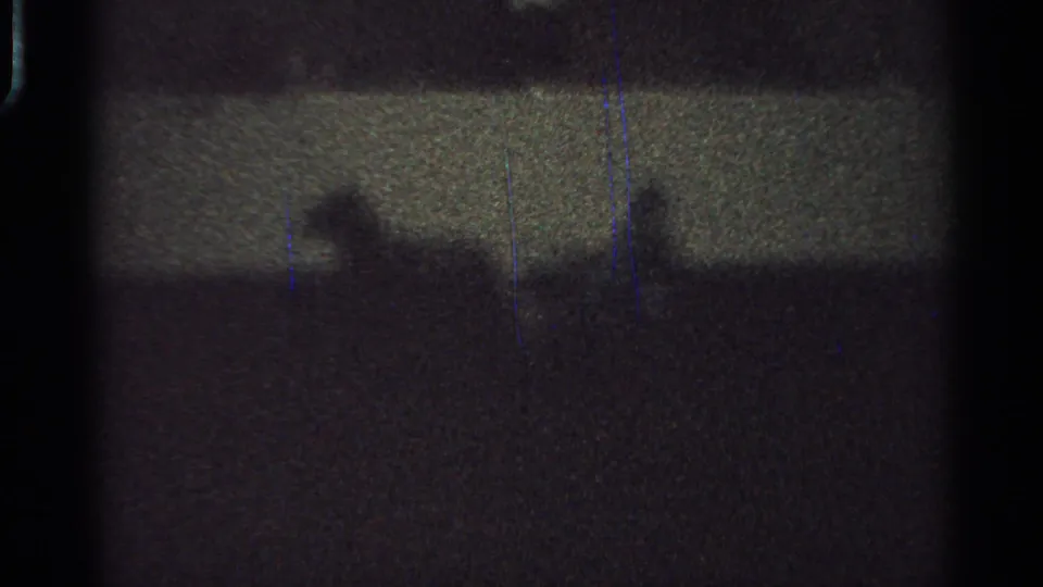 A silhouetted horse and rider are faintly visible in the 1965 Saint Louis home-movie frame, with grain and blue scratches over the scan.