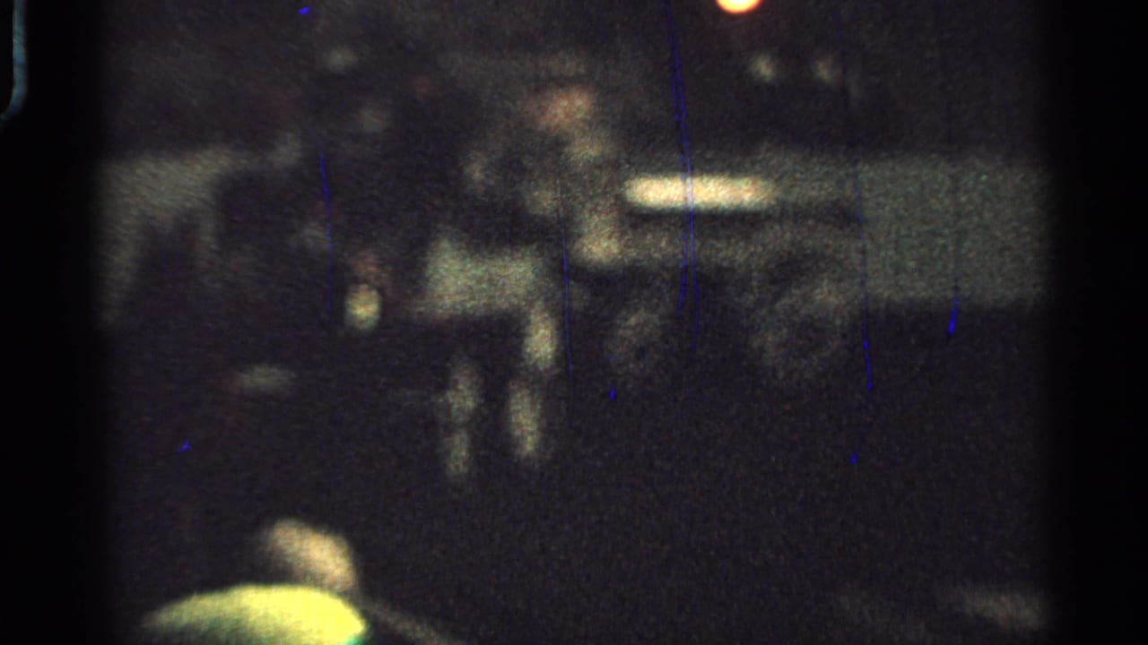 A shaky 8mm frame from Saint Louis in 1965 appears to show the carriage and riders in soft focus at night.