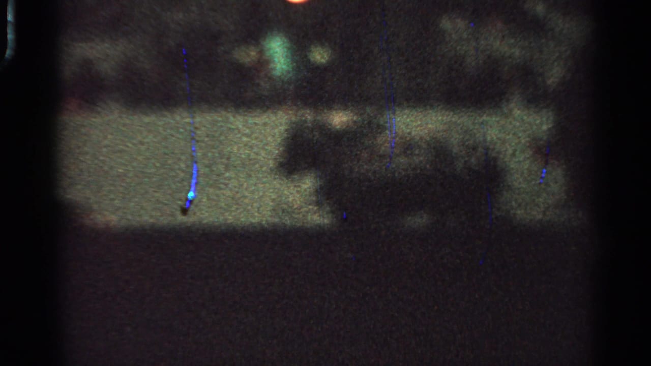 The horse-drawn carriage is more visible as a dark profile in a grainy 1965 Saint Louis night shot.