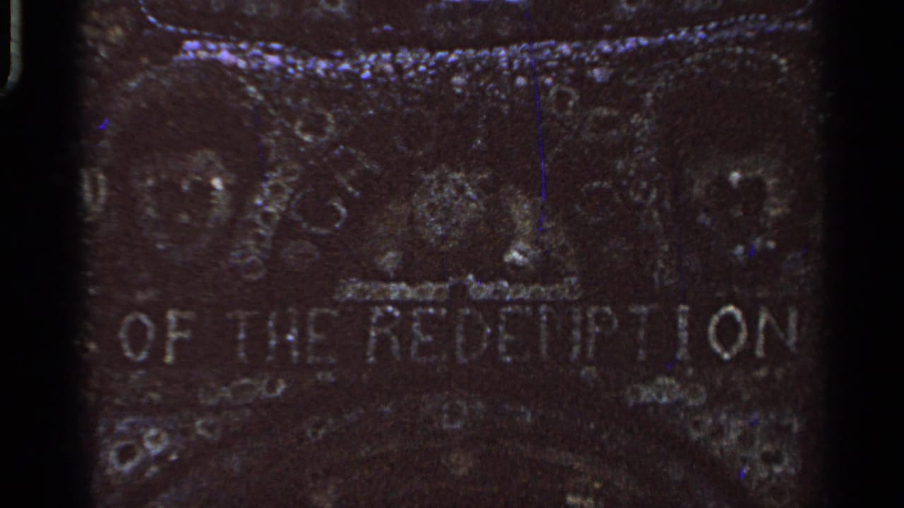 Weathered stone surface with partial Grotto of the Redemption lettering.
