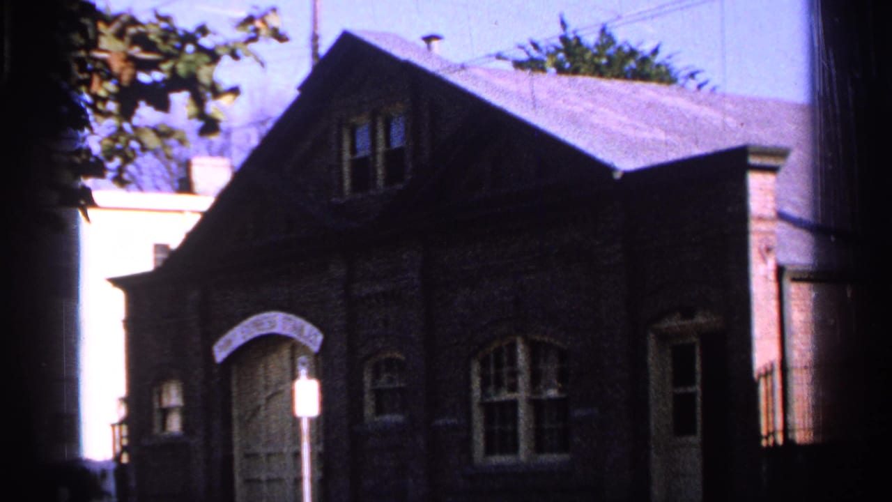 Similar exterior view of Pony Express Stables with arched entrance, windows, roof, and signpost.