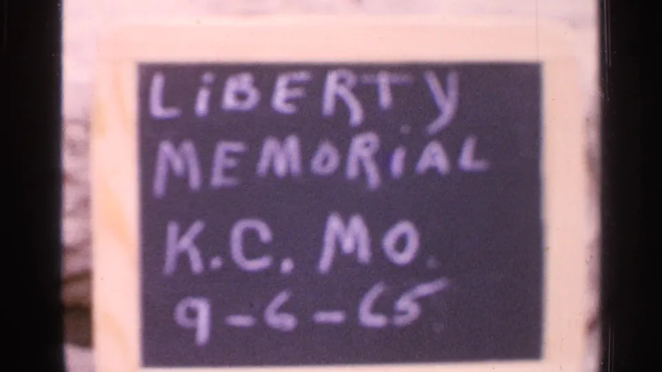 Closer soft 8mm frame of the handwritten slate reading Liberty Memorial, K.C. Mo., 9-6-65.