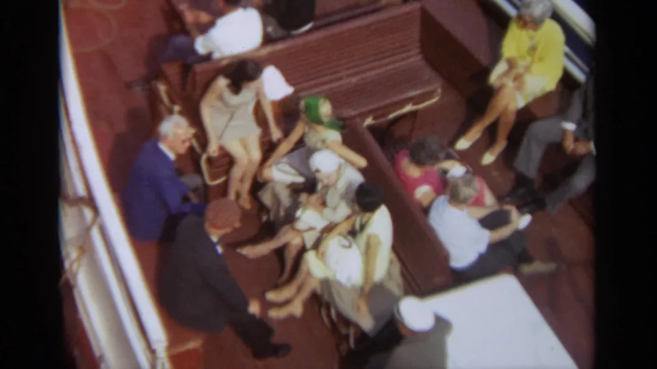 Closer 1965 Stockholm ship-deck view with passengers seated on benches and others standing nearby.