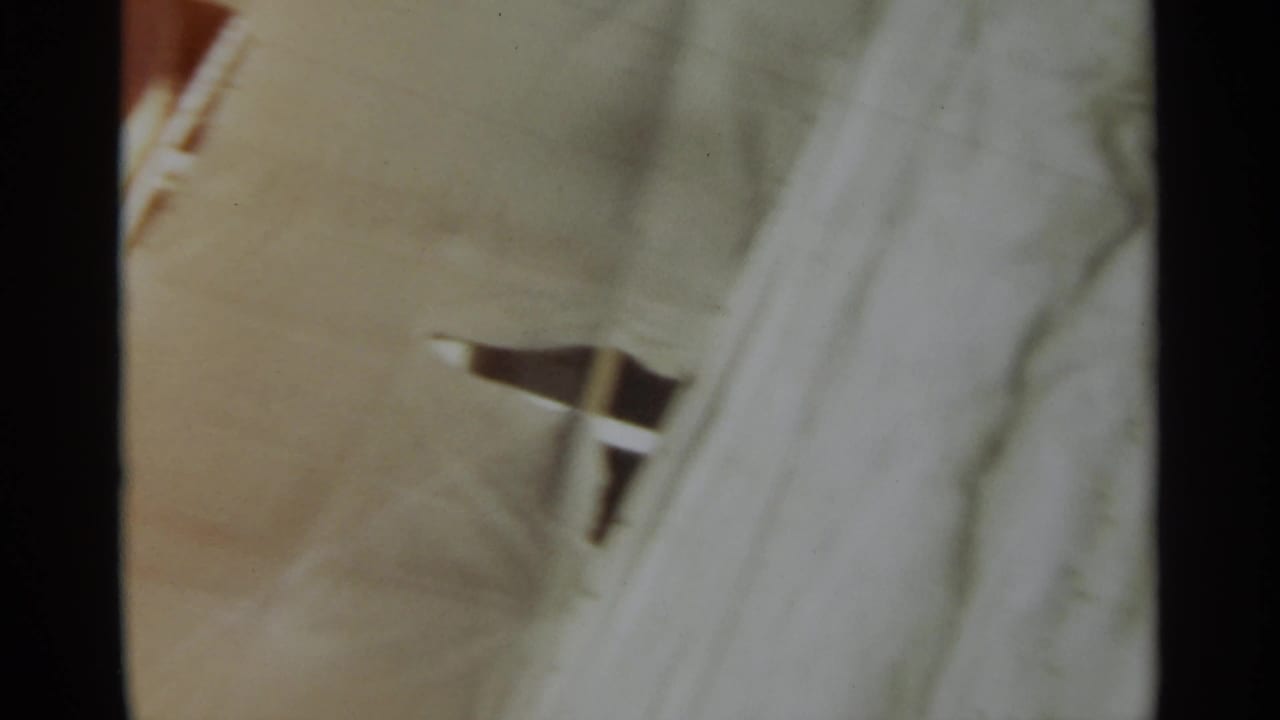 Pale ship deck surface with a small railing or fixture partly visible near the right side.