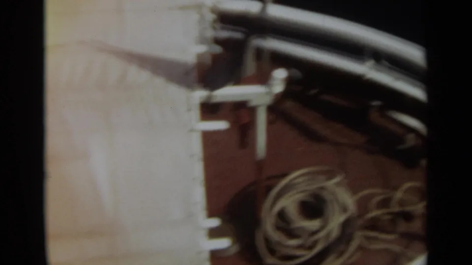 Top-down 8mm view of a Stockholm ship deck with coiled rope, railing hardware, and dark curved deck equipment.