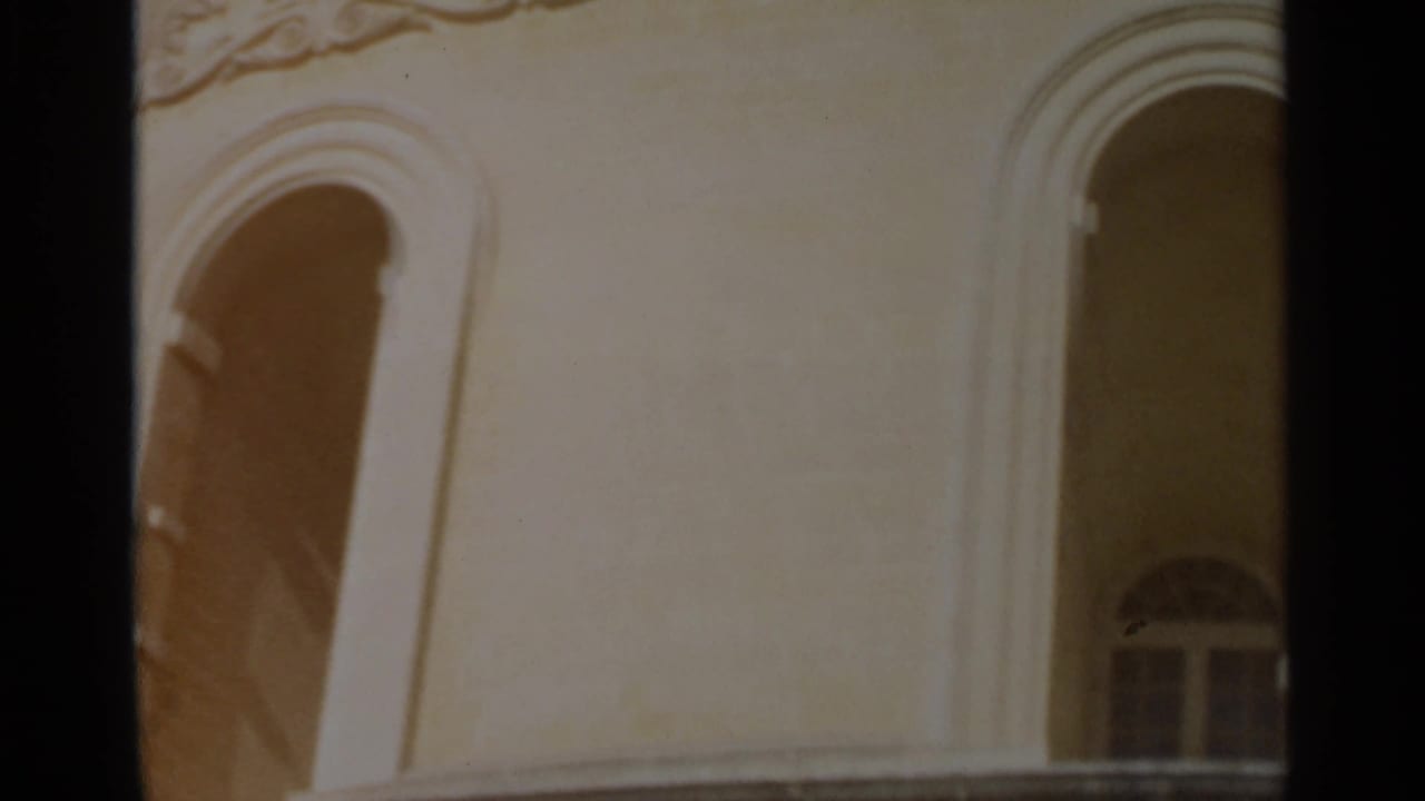 1965 Tangier frame with tall arched window openings, pale wall surfaces and a dark vertical film edge.