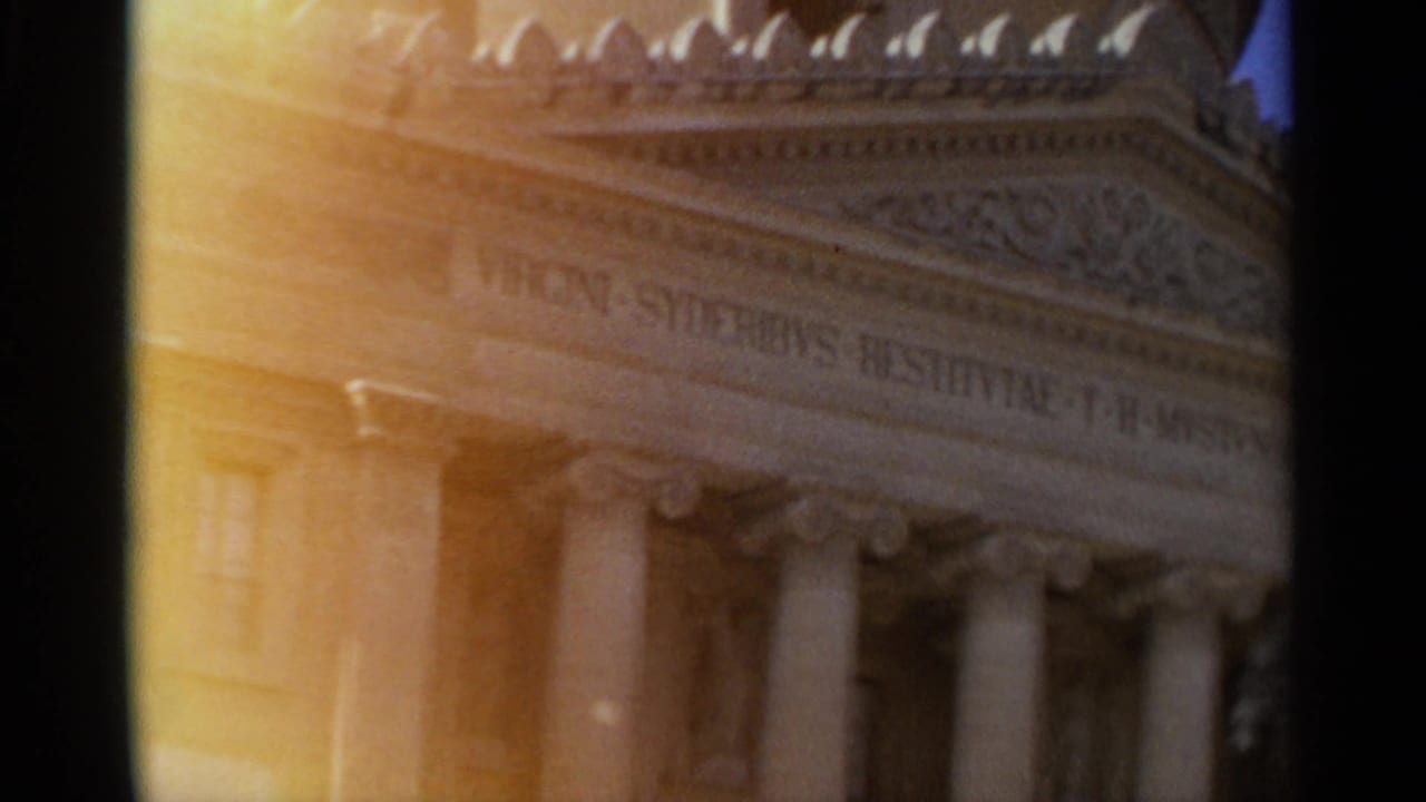 1965 Tangier frame with a classical columned facade, carved pediment detail, and partially visible Latin lettering.