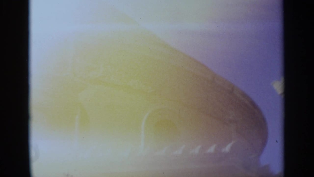 Soft 8mm frame of a large church dome seen through dark film-frame borders.