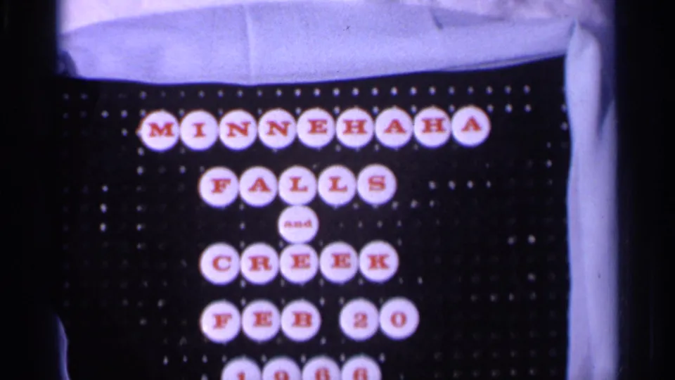 1966 8mm title card for Minnehaha Falls and Creek, arranged with red letters on white circles against a black backing.