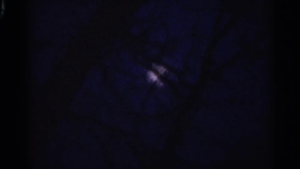 The final sampled frame is very underexposed, with faint blue tone and small light marks visible within the 8mm frame.
