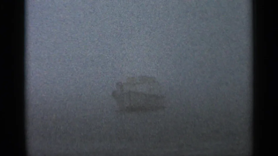 A small boat appears on a mist-covered lake in a 1966 Hamel, Minnesota home-movie frame.
