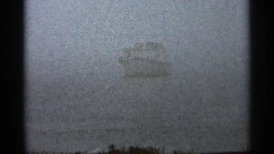 A fog-softened boat silhouette appears over water in the Hamel, Minnesota home-movie footage from 1966.