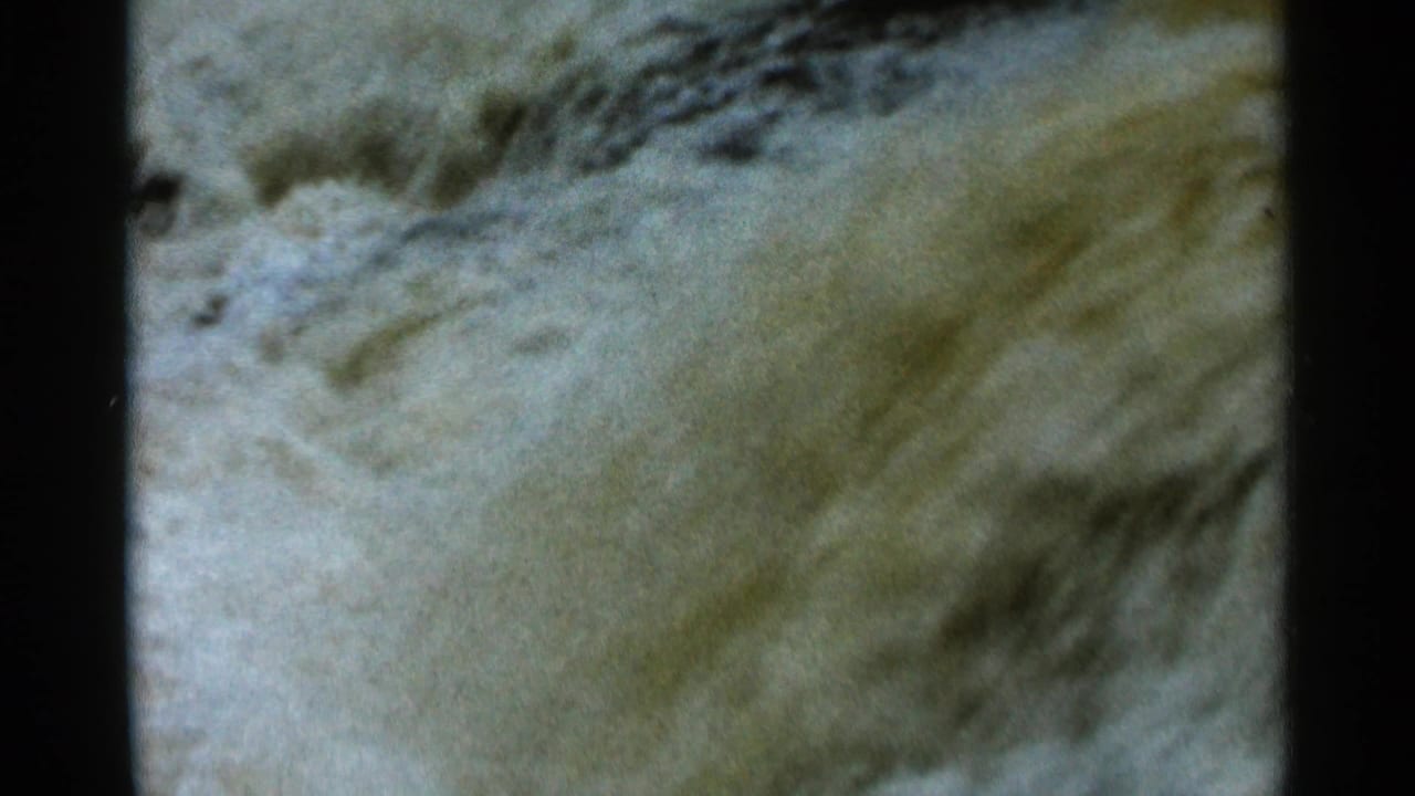 Close view of pale, fast-moving water filling most of the frame.