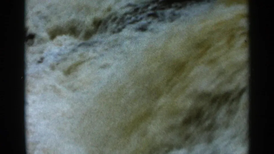 Soft 8mm frame of fast, pale muddy current, with blurred texture suggesting rapids near Hamel, Minnesota in 1966.