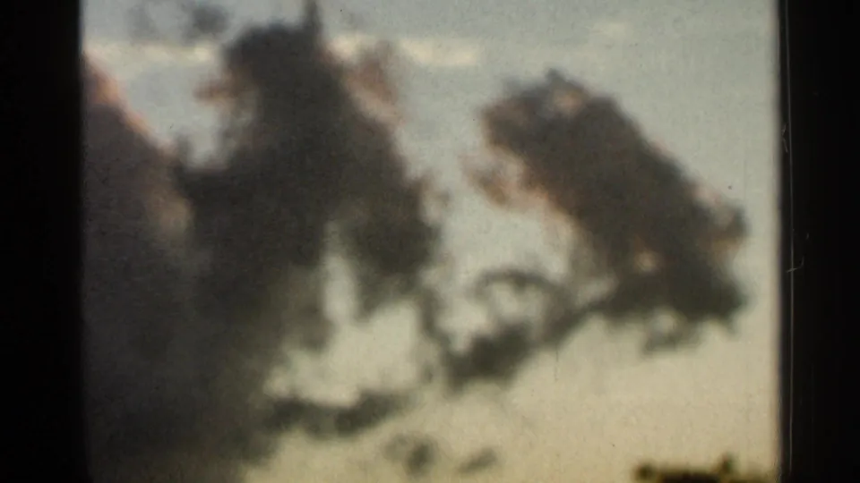 Archival 8mm frame from the Hamel, Minnesota sky sequence showing diffuse darker cloud forms in pale light.