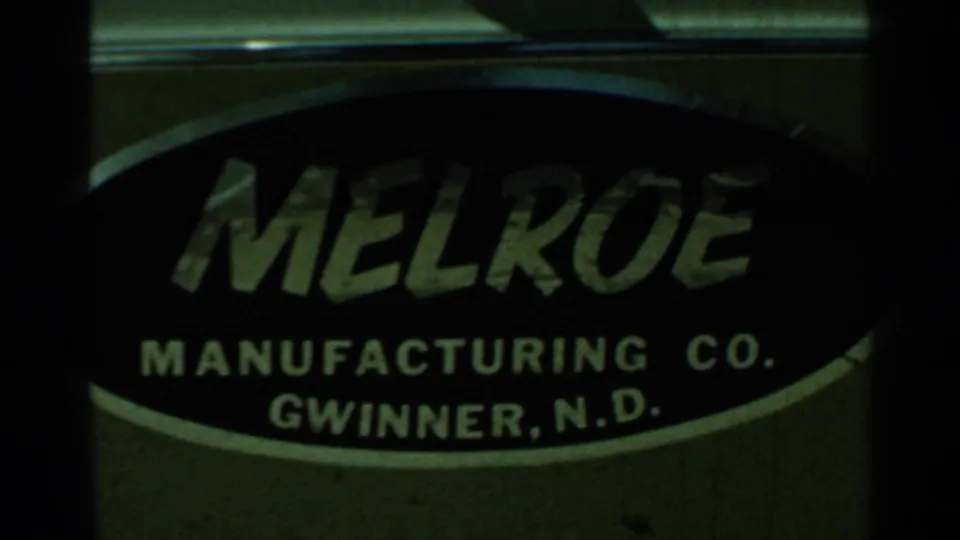 1966 8mm frame showing a Melroe Manufacturing Co. Gwinner, N.D. logo on a dark oval label.