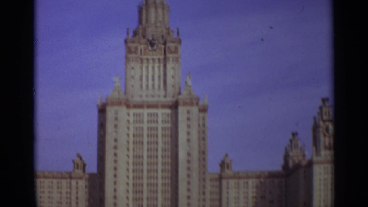 Moscow State University central tower against a blue sky, framed closely on 8mm film.