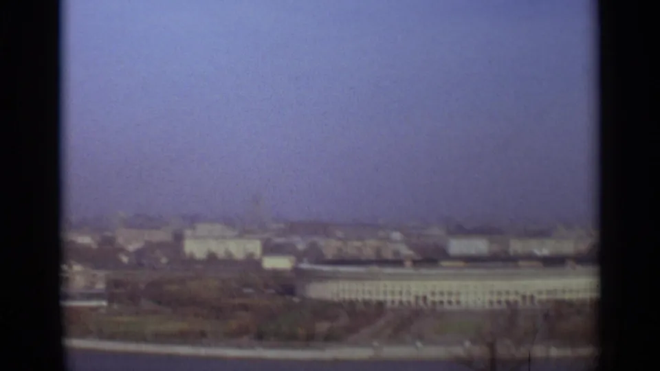 1966 Moscow panoramic view with a long pale building, open foreground, distant rooftops, and a hazy sky.