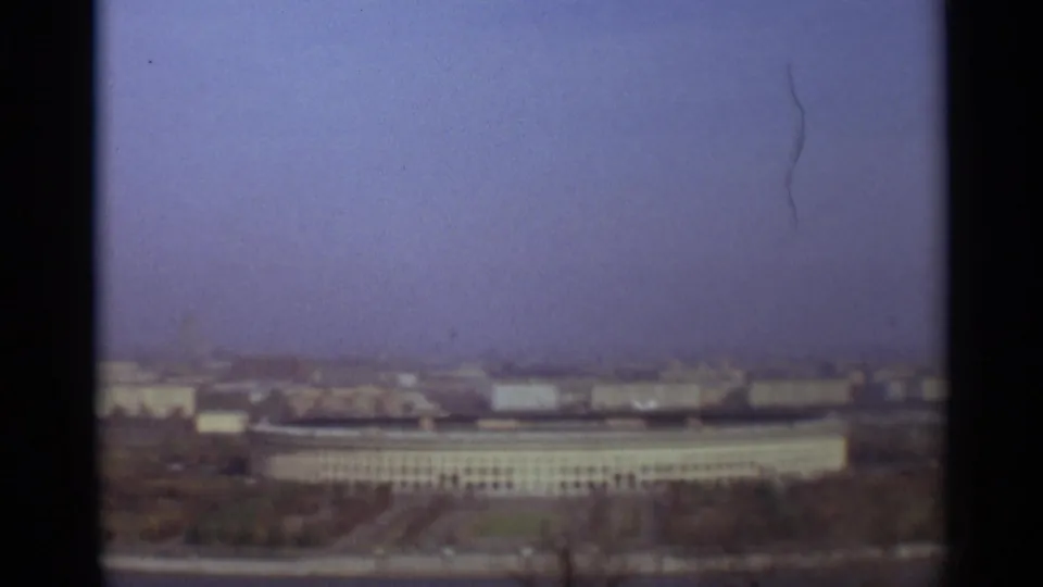 1966 Moscow home-movie frame showing a soft, hazy elevated view of broad buildings and a distant skyline.
