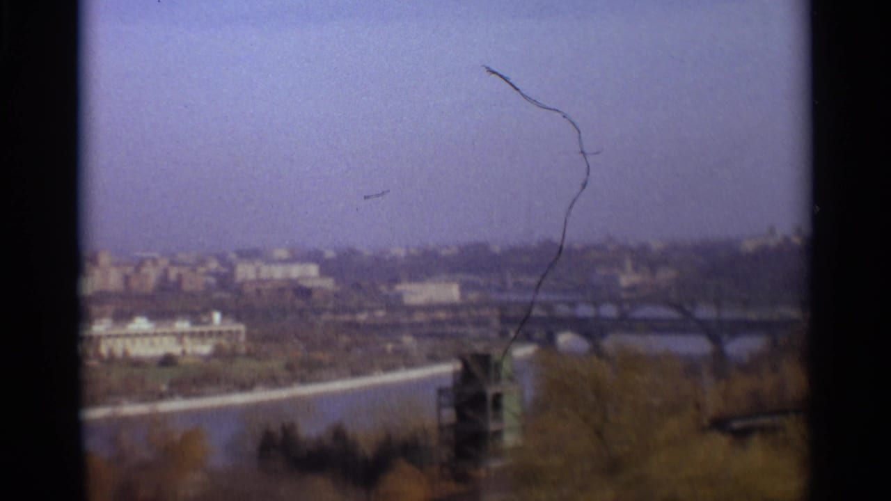 Soft 8mm view over a river, arched bridges, trees, and distant Moscow buildings.