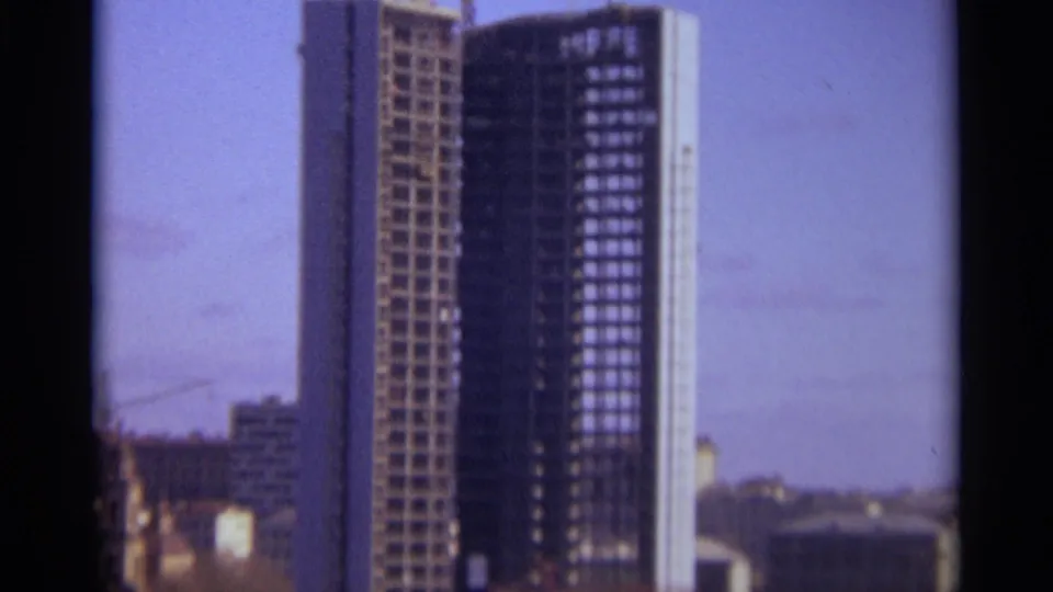 1966 Moscow 8mm frame of the unfinished tower framed against sky, with construction equipment and lower city blocks visible nearby.