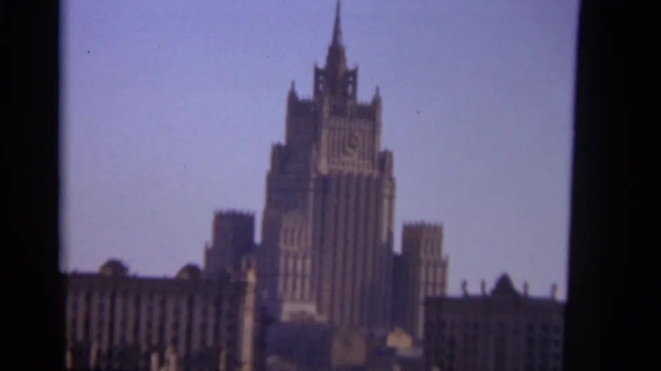 1966 Moscow frame of the Ministry of Foreign Affairs building, seen in faded color with visible 8mm grain and soft focus.