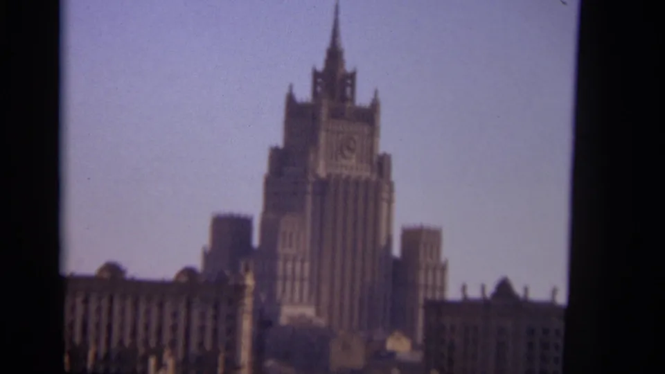 1966 Moscow frame with the Ministry of Foreign Affairs building in soft focus, surrounded by lower rooflines and film borders.