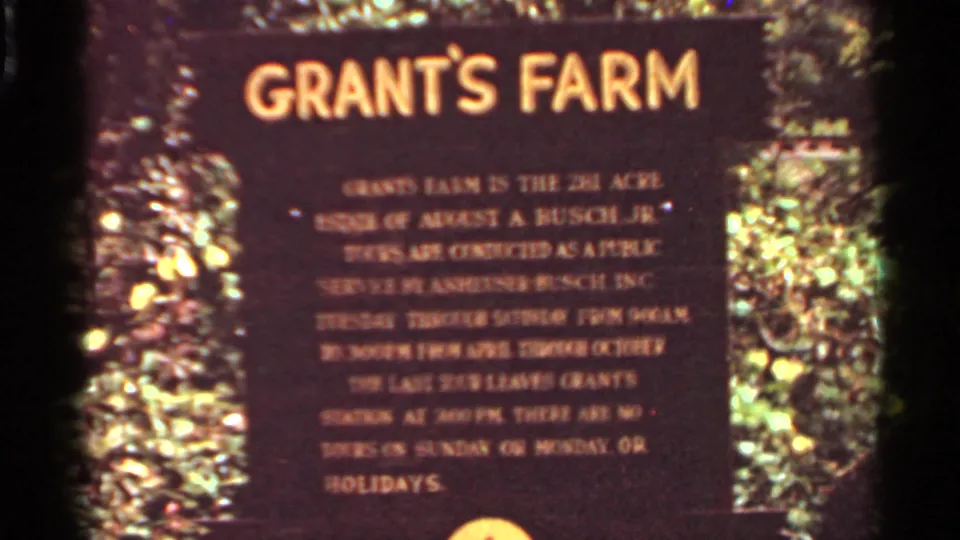 Grant's Farm sign in Saint Louis, Missouri, with readable title and smaller visitor information text in a soft 8mm frame.