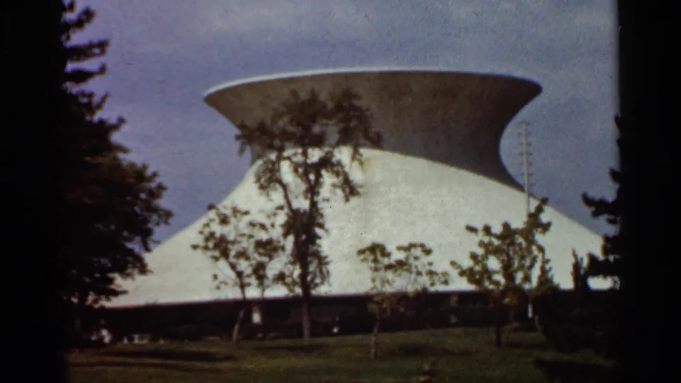 Closer 1966 St. Louis view of the modernist building's sweeping white wall and circular roof edge.