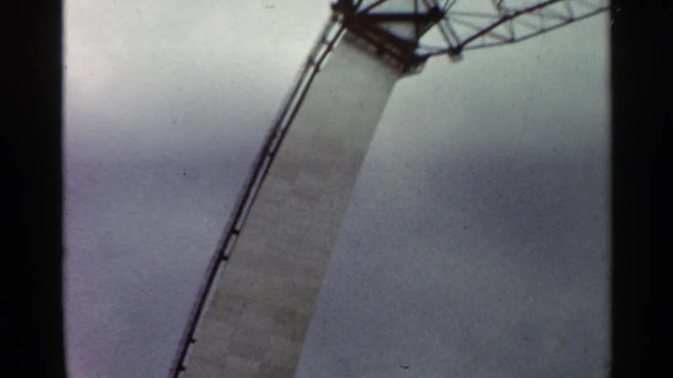 Low-angle 1966 Saint Louis construction frame showing a curved scaffold line beside an unfinished concrete structure.