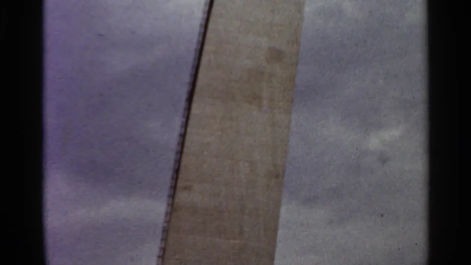 Tight 1966 Saint Louis view of a vertical concrete construction element with sky visible beside it.