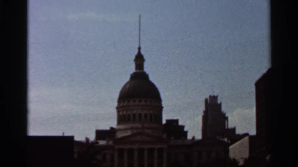 1966 Saint Louis skyline view showing a domed civic building with spire, columns, and surrounding downtown structures.