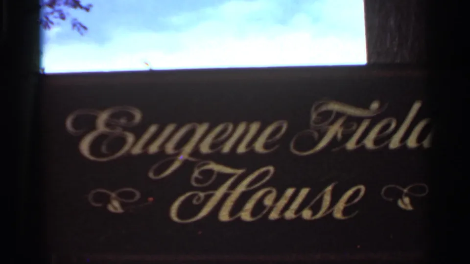 Close 1966 Saint Louis frame showing the Eugene Field House sign in script lettering below a bright sky area.