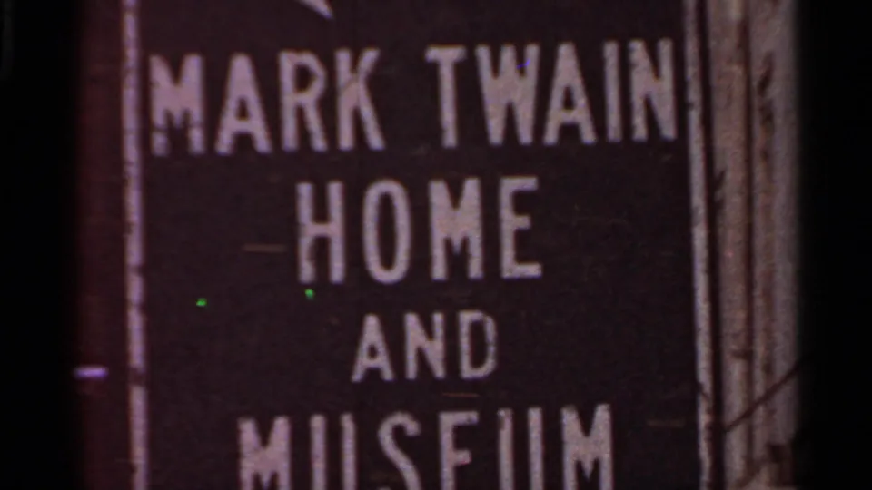 Close-up 1966 frame of a sign reading Mark Twain Home and Museum, used as a location-identifying shot.