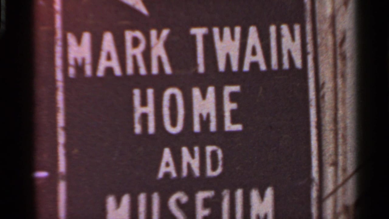 1966 8mm frame from Missouri showing a close-up of the Mark Twain Home and Museum sign with bold white lettering.