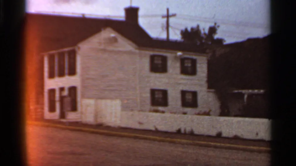 1966 Missouri frame showing the Mark Twain Home and Museum exterior from a visitor's roadside viewpoint.