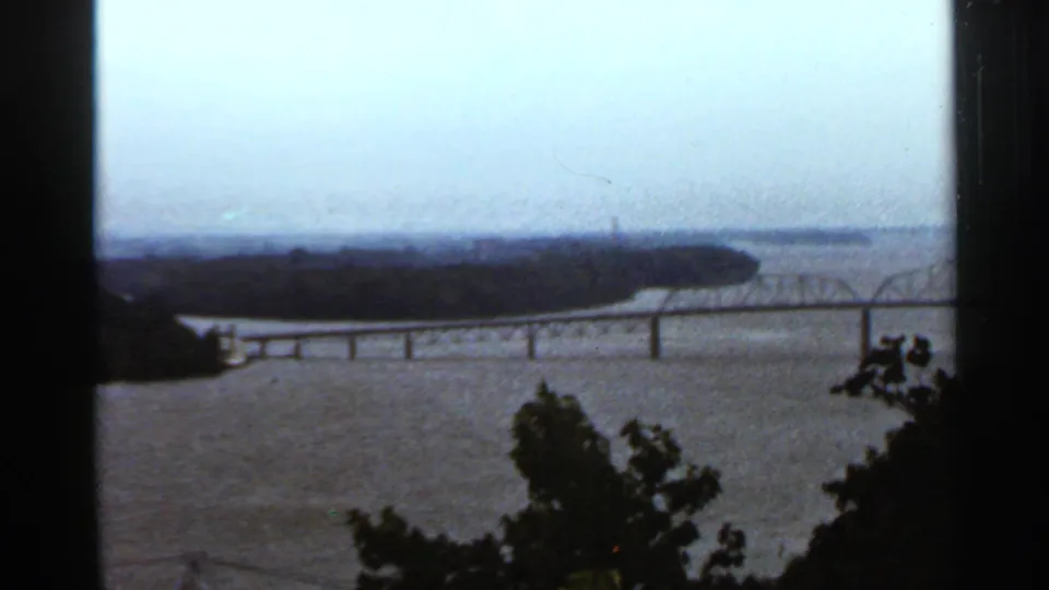 1966 Saint Louis 8mm view looking across a wide river from an overlook with railing and distant landforms.