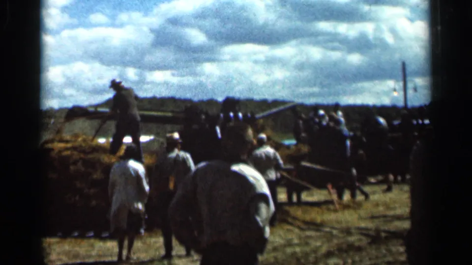 Wauseon, Ohio threshing-show footage showing people around hay handling equipment in a rural field in 1966.