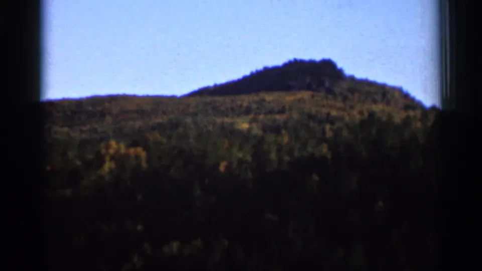 Soft 8mm landscape frame showing a wooded hill and low ridgeline near Wauseon, Ohio, with visible film borders.