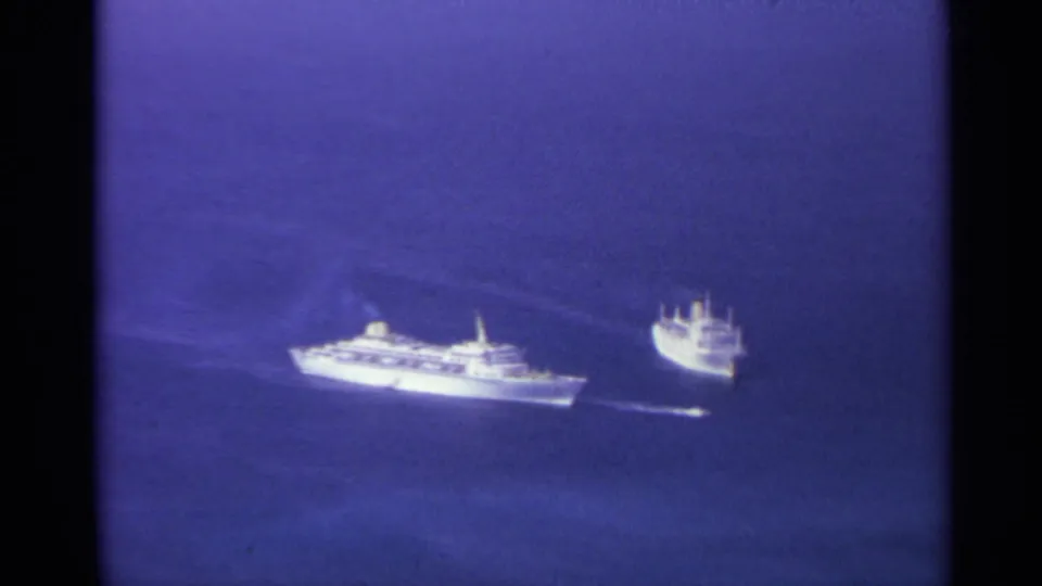 The final 1967 US Virgin Islands frame holds on two distant white ships against blue ocean and hazy 8mm color.