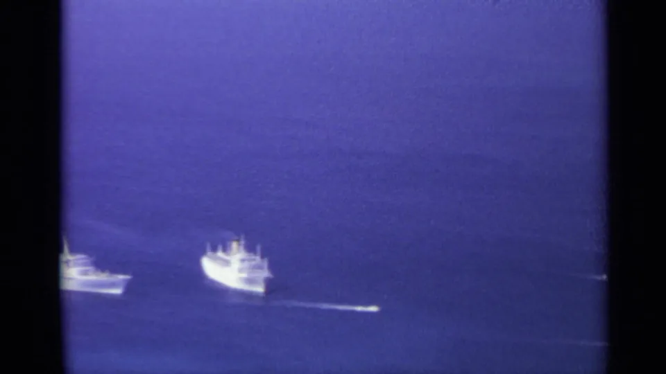Late frame from the 1967 8mm clip shows the vessels partly cropped near the bottom as they pass through blue open water.