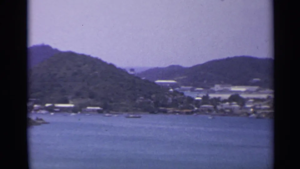 1967 8mm coastal view in the US Virgin Islands with wooded hills and shoreline development.