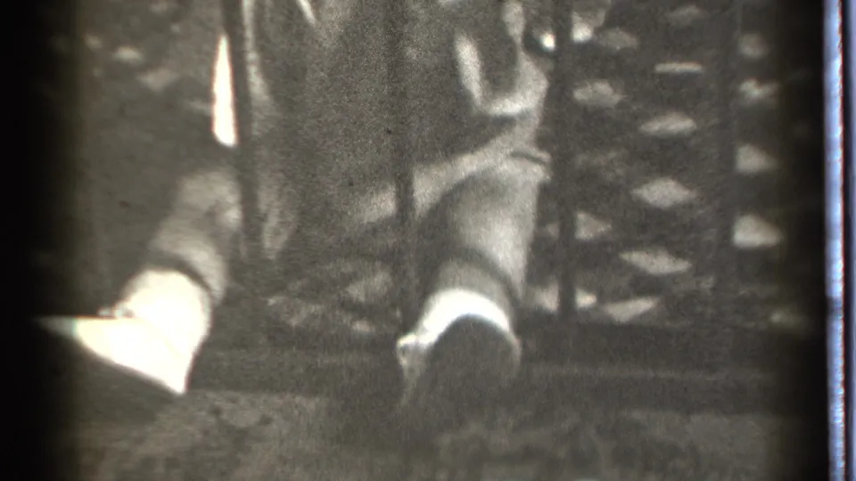 The final frame shows the baby close to the dark bar, partly turned and softly focused against the patterned railing in Danielson, Connecticut footage.